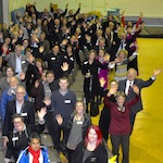 The crowd waves for the camera at the 2016 annual meeting